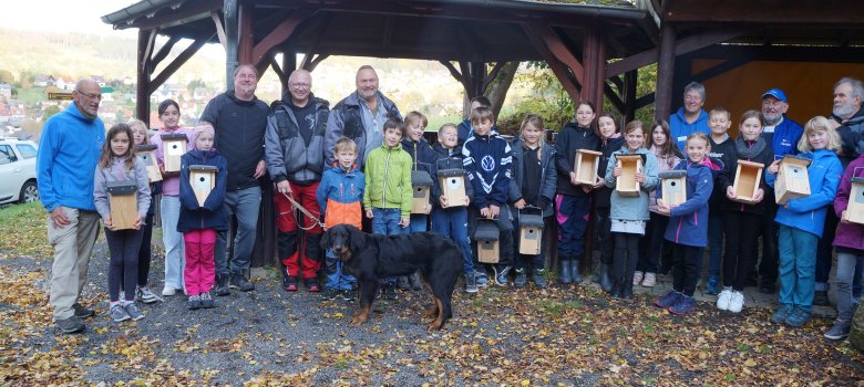 Aktion Nistkästchen Bauen und Anbringen. Kinder und Erwachsene auf einem Gruppenbild 